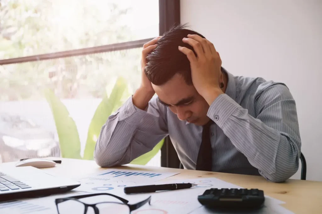 A young man is tired of doing office work. 